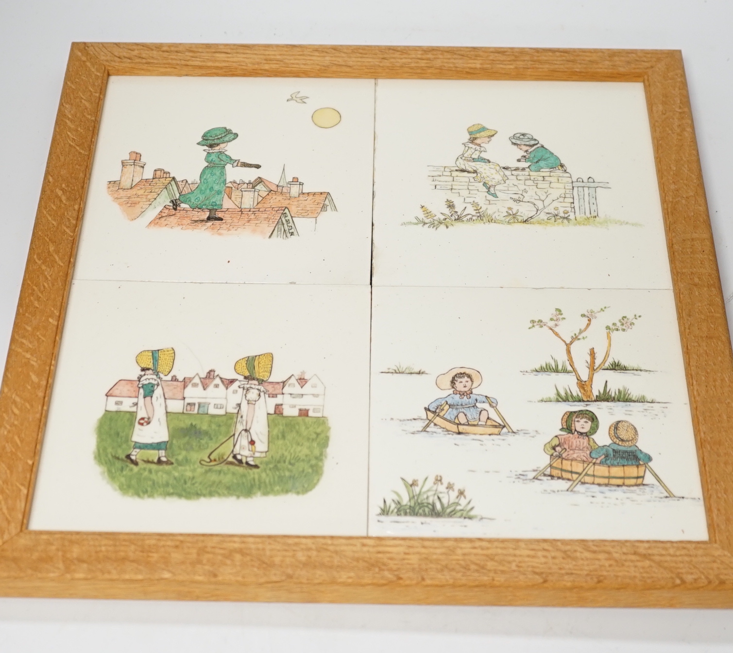 A set of four oak framed Minton tiles outside decorated illustrations after Kate Greenaway, 34 x 34cm